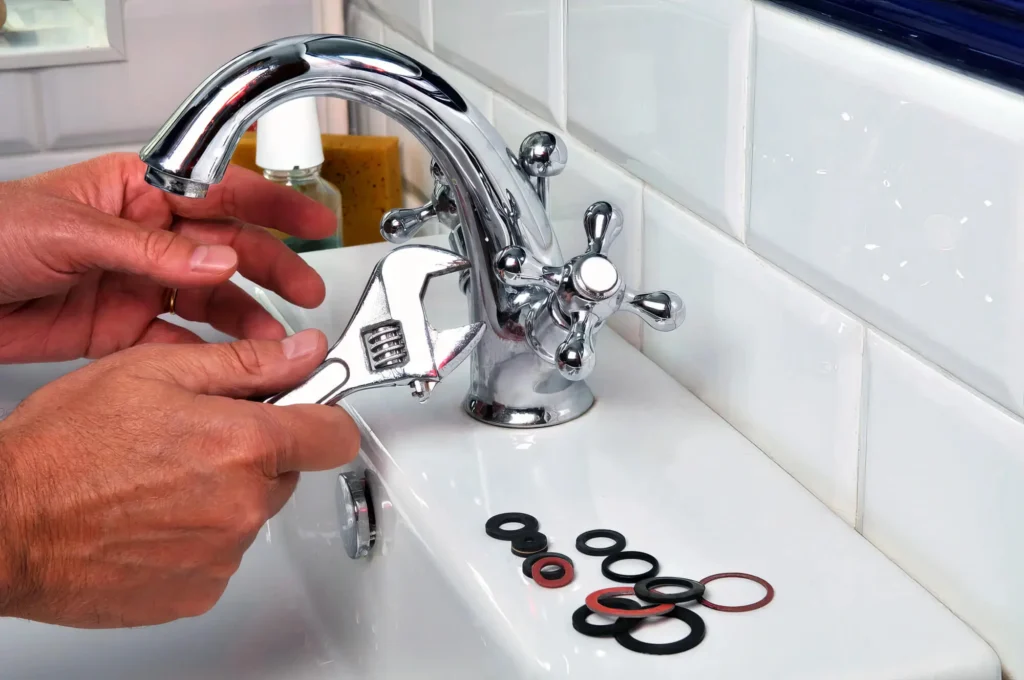 Plumber performing maintenance on a bathroom faucet in Haines City
