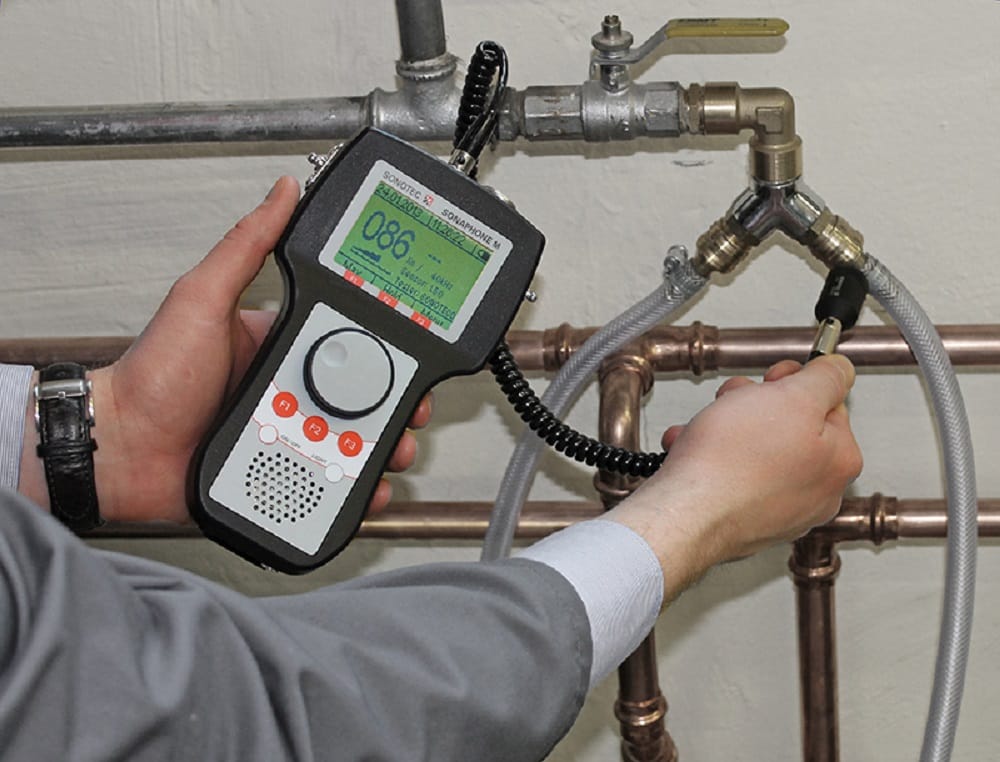 Plumber testing pipes with electronic leak detection equipment in Haines City