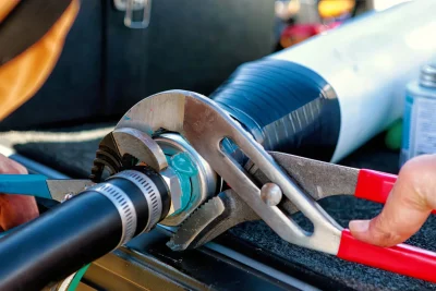 Technician tightening an industrial pipe connection in Haines City