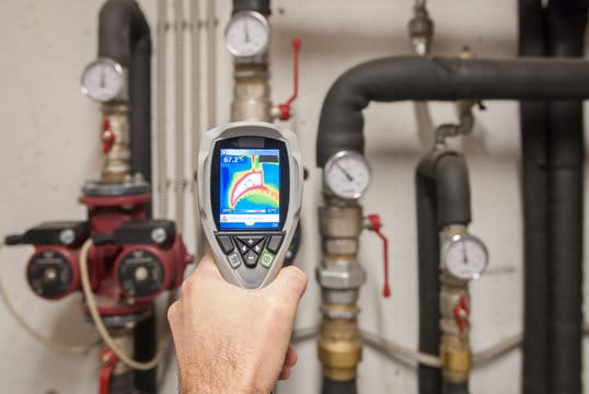 Plumber using a thermal imaging camera to inspect pipes in Haines City