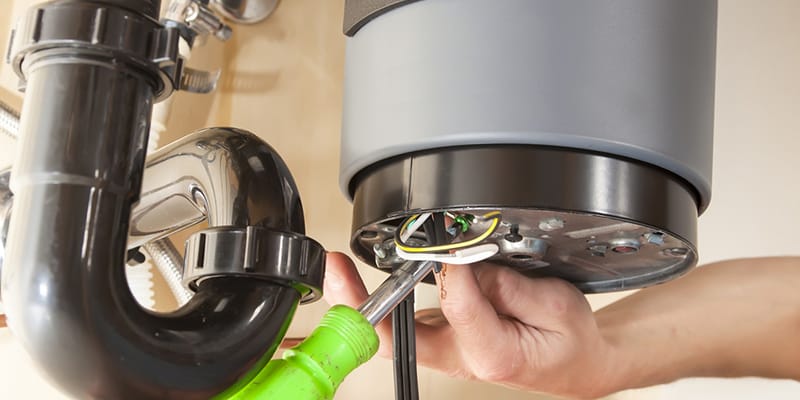 Technician repairing the heating element of a water heater in Haines City