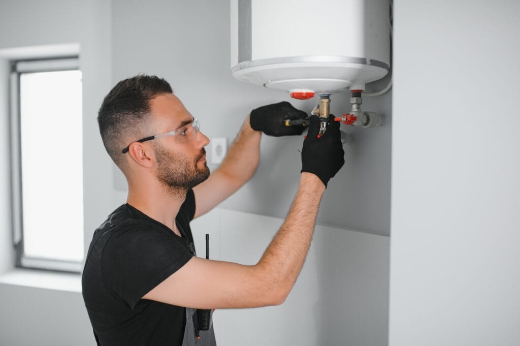 Technician performing water heater maintenance in Haines City