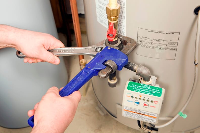 Plumber repairing a water heater valve in Haines City